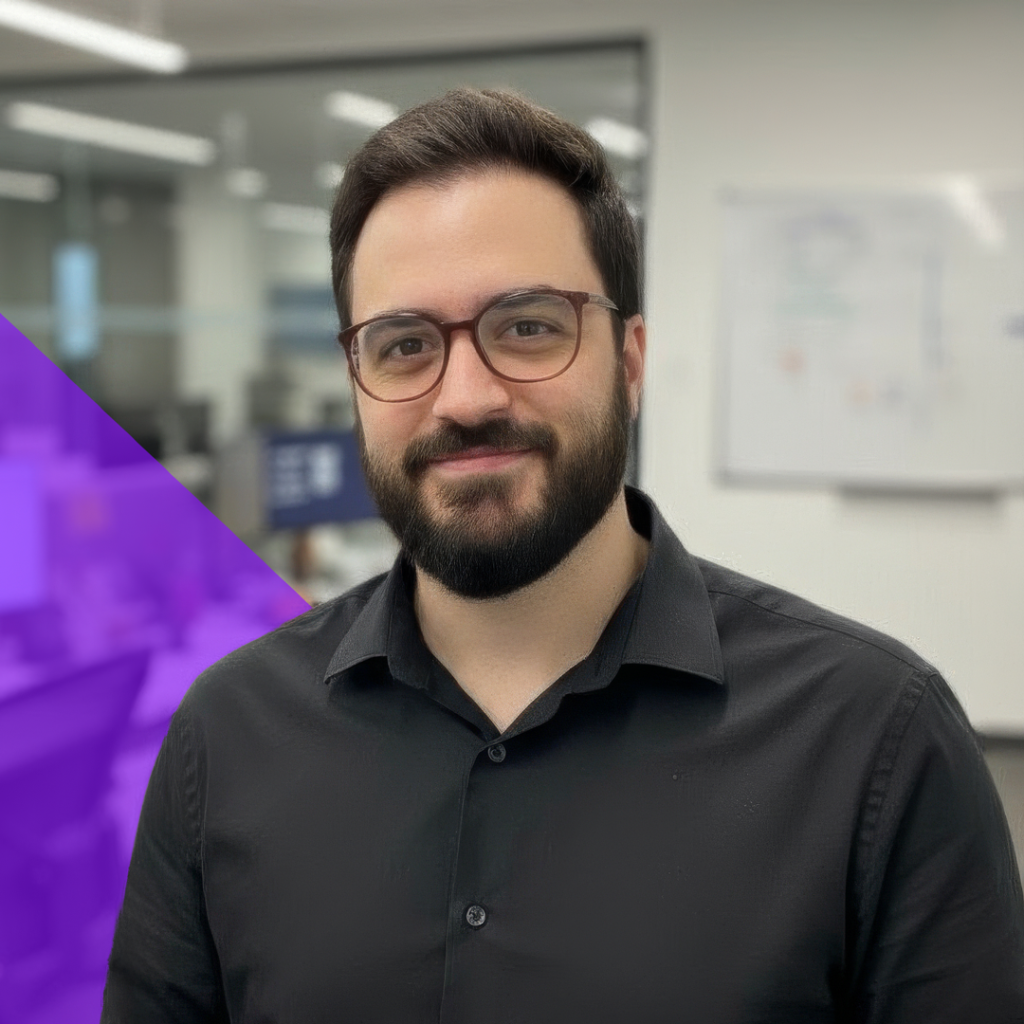 Austin Arterburn, IT Manager at Total Service, smiling in a professional setting with a modern office background and a purple geometric design element.