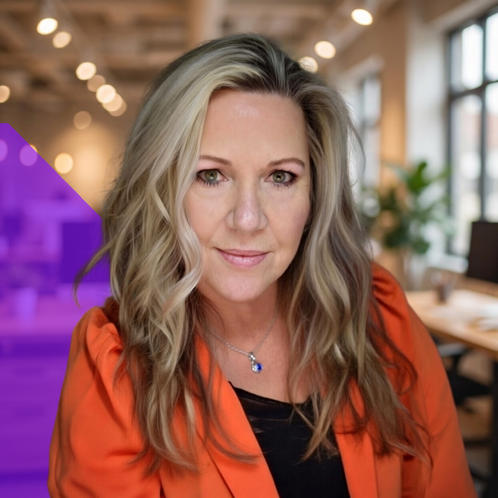 Barbara Mathewes, Director of Client Operations at Total Service, wearing an orange blazer, posing confidently in a modern office setting with greenery and soft lighting in the background.