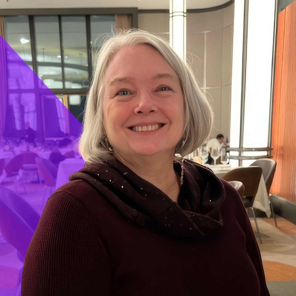 Diana Hall, Lead Software Consultant at Total Service, smiling in a modern setting, showcasing her role in enhancing customer experience and innovative software solutions for the elevator service industry.