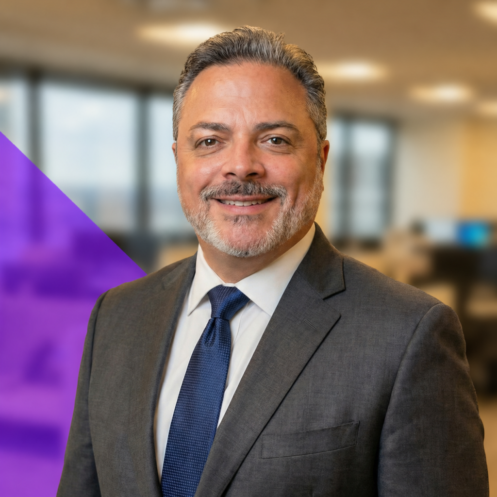 Robert Guadalupe, Business Development Manager at Total Service, smiling in a professional setting, wearing a suit and tie, with a blurred office background and a purple graphic element.